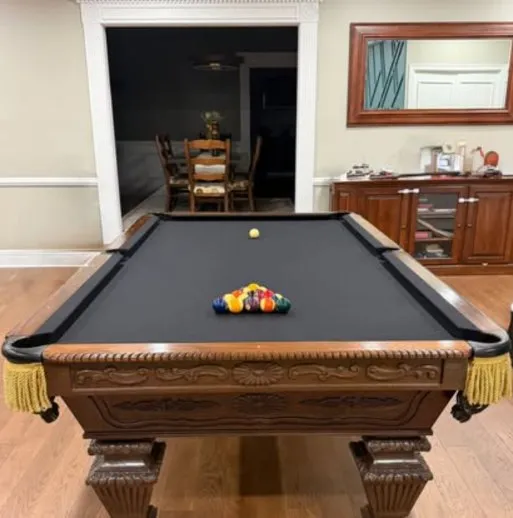 Carved dark wood table with black felt and fringe pockets