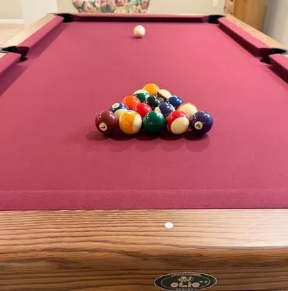 Racked balls on burgundy felt