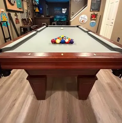 Cherry table with gray felt in a basement bar