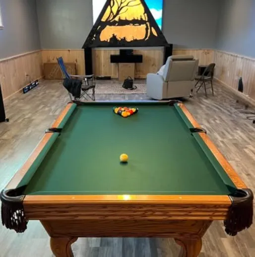 Oak table with green felt in a lodge-style room